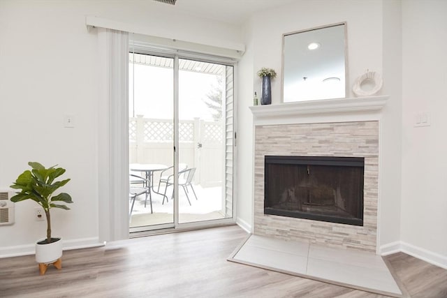 living room featuring hardwood / wood-style flooring and a fireplace