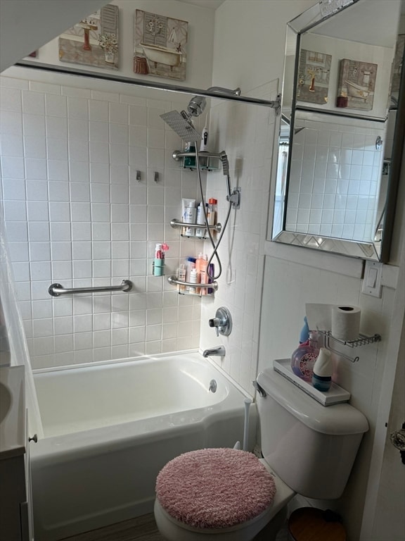 full bathroom featuring toilet, vanity, and tiled shower / bath