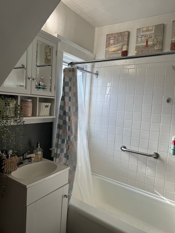 bathroom featuring shower / bath combo and vanity