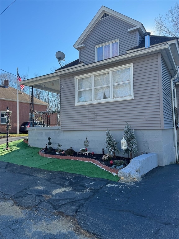 view of side of home with a porch