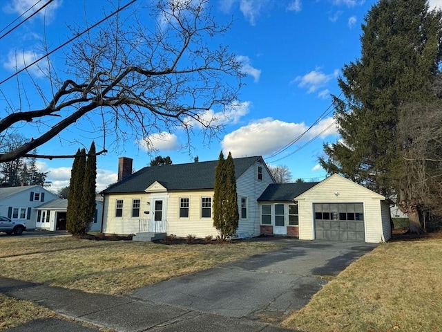 view of front of house with a garage and a front lawn