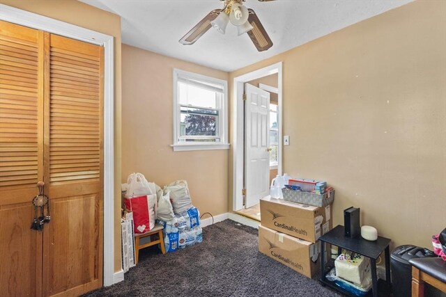 recreation room with a ceiling fan, carpet, and baseboards