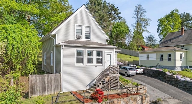 view of front of house with fence and stairway