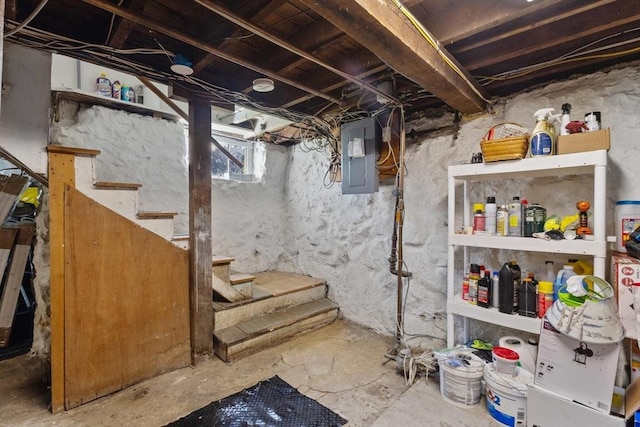 basement with electric panel and stairway