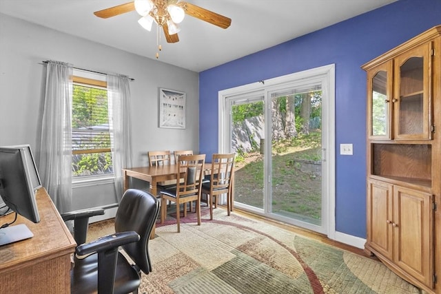 home office featuring ceiling fan, light wood finished floors, and baseboards