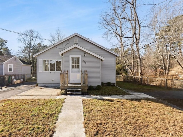 bungalow-style home featuring a front yard