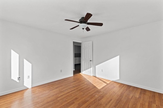 empty room with light wood-type flooring and ceiling fan