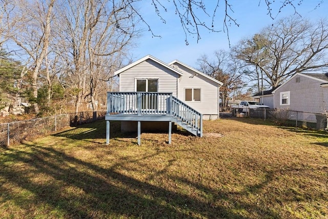 rear view of property with a yard and a deck