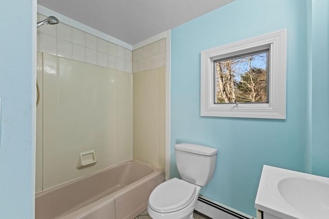 full bathroom featuring vanity, toilet, tiled shower / bath, and a baseboard radiator