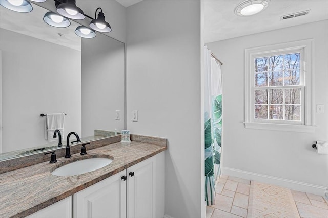 bathroom featuring tile patterned flooring and vanity