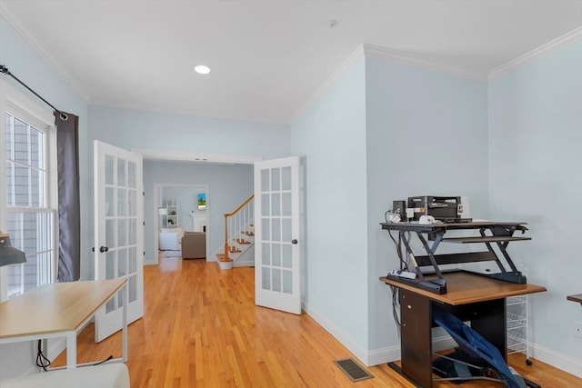 hall with light hardwood / wood-style floors, crown molding, and french doors