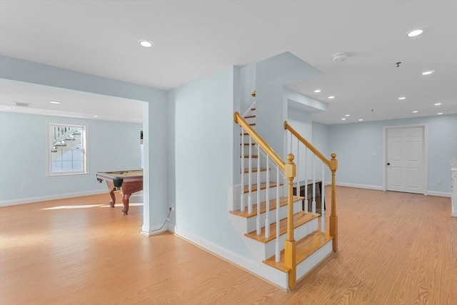 staircase featuring hardwood / wood-style flooring and pool table