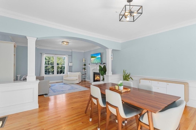 dining space with light hardwood / wood-style flooring and ornamental molding