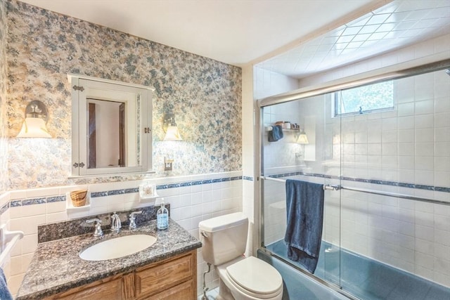 22 Sycamore Rd, Weymouth, MA 02190 - full bath featuring wallpapered walls, bath / shower combo with glass door, vanity, tile walls, and a wainscoted wall