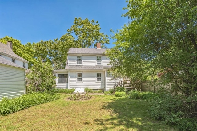 22 Sycamore Rd, Weymouth, MA 02190 - back of house featuring a lawn and a chimney