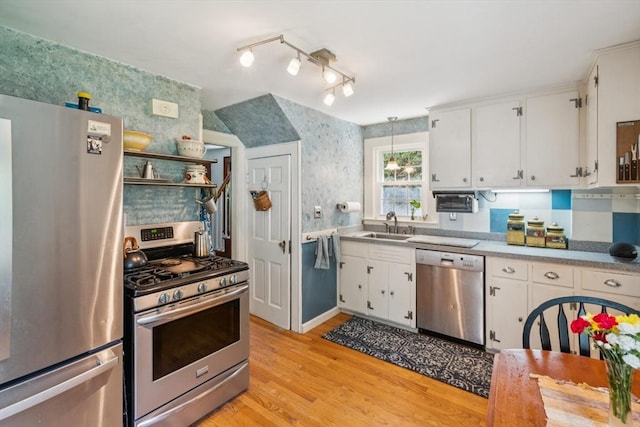 22 Sycamore Rd, Weymouth, MA 02190 - kitchen featuring appliances with stainless steel finishes, a sink, light wood-type flooring, white cabinets, and light countertops