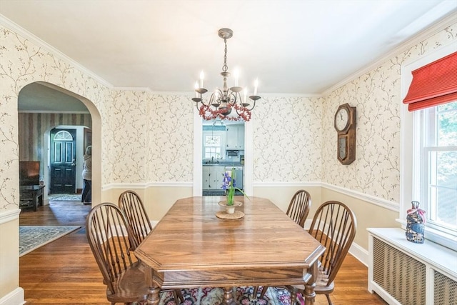 22 Sycamore Rd, Weymouth, MA 02190 - dining area featuring radiator heating unit, wallpapered walls, wood finished floors, a chandelier, and a wainscoted wall