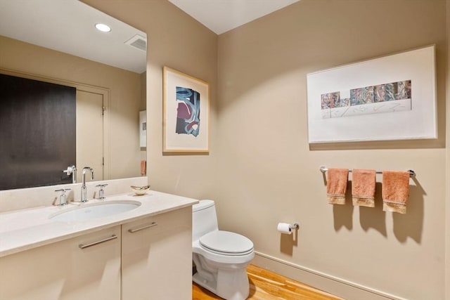2400 Beacon St Unit 203, Boston, MA 02467 - half bathroom with toilet, vanity, wood finished floors, and baseboards