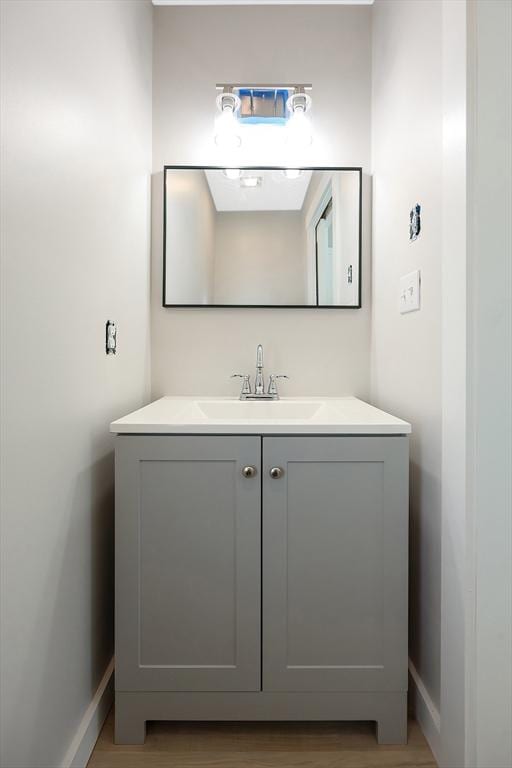 bathroom with vanity and hardwood / wood-style floors