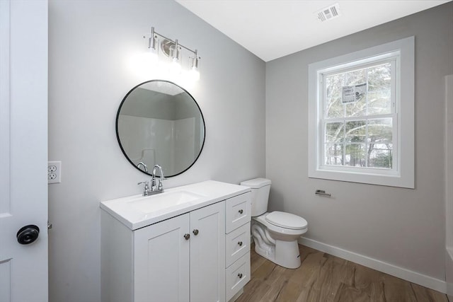 bathroom featuring hardwood / wood-style flooring, vanity, and toilet