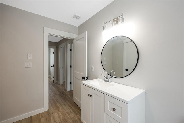 bathroom featuring vanity and hardwood / wood-style floors