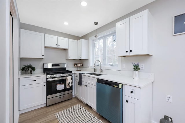 kitchen featuring stainless steel appliances, white cabinetry, and sink