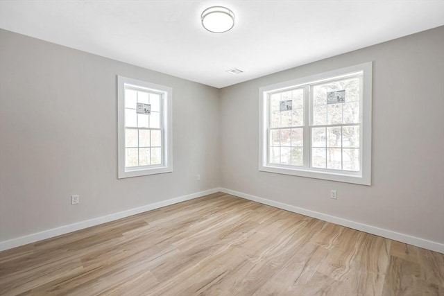 unfurnished room featuring light hardwood / wood-style floors