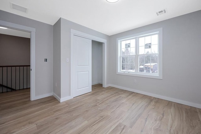 unfurnished bedroom featuring a closet and light hardwood / wood-style flooring