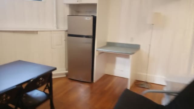 kitchen with dark wood-type flooring and stainless steel refrigerator