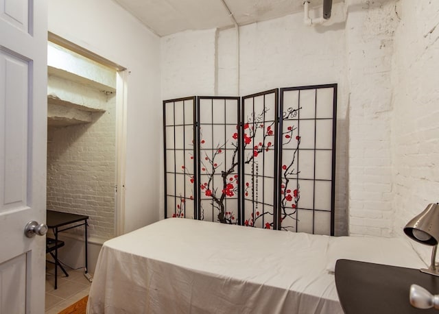 bedroom with brick wall