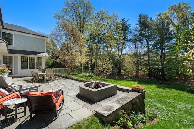 view of patio featuring a fire pit and outdoor dining area
