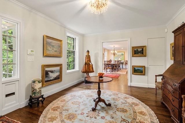 living area with a chandelier, dark wood-type flooring, crown molding, and baseboards