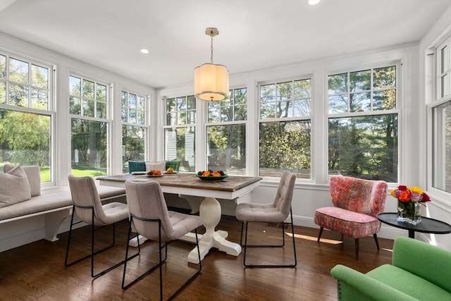 sunroom with healthy amount of natural light, wood finished floors, and recessed lighting
