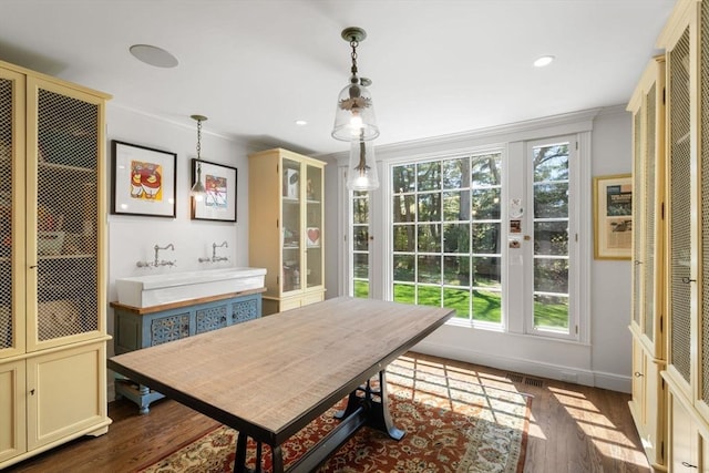 dining space with ornamental molding, dark wood-style flooring, and recessed lighting