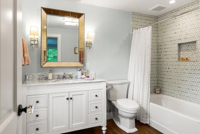 full bath with wood finished floors, toilet, vanity, and shower / tub combo with curtain