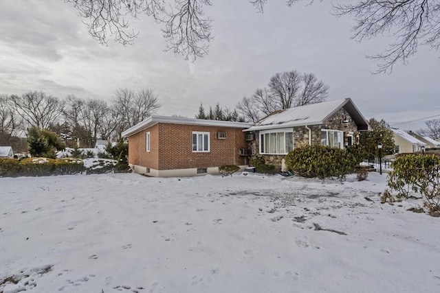 view of front of property featuring stone siding and brick siding