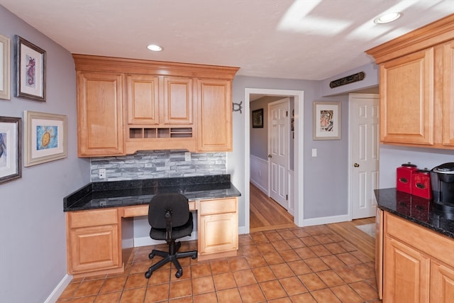 office space featuring built in desk and light tile patterned flooring