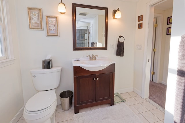 bathroom with toilet, vanity, and tile patterned floors