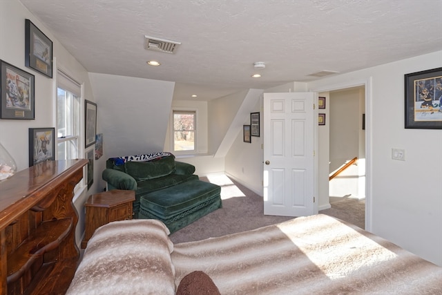 living room with a textured ceiling and dark carpet