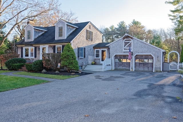 cape cod house featuring a garage