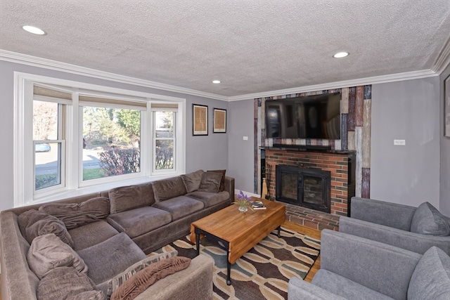 living room featuring a fireplace, hardwood / wood-style floors, a textured ceiling, and crown molding