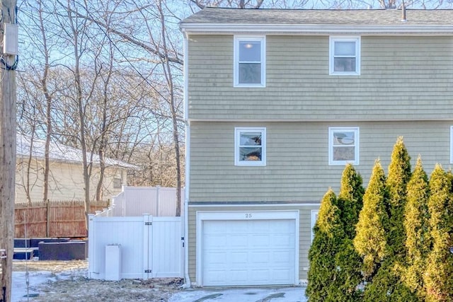 rear view of property with a garage