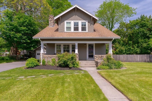 181 Lowell St, Andover, MA 01810 - craftsman-style home with stone siding, covered porch, a chimney, a shingled roof, and a garage