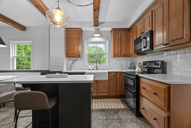 181 Lowell St, Andover, MA 01810 - kitchen featuring black appliances, beam ceiling, brown cabinets, and light countertops
