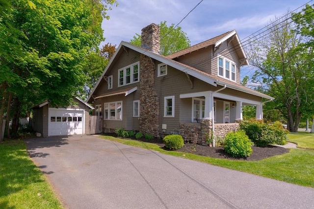 181 Lowell St, Andover, MA 01810 - view of front facade with an outdoor structure, a chimney, a garage, a porch, and driveway