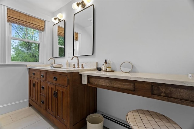 181 Lowell St, Andover, MA 01810 - full bath with double vanity, tile patterned floors, and a baseboard heating unit