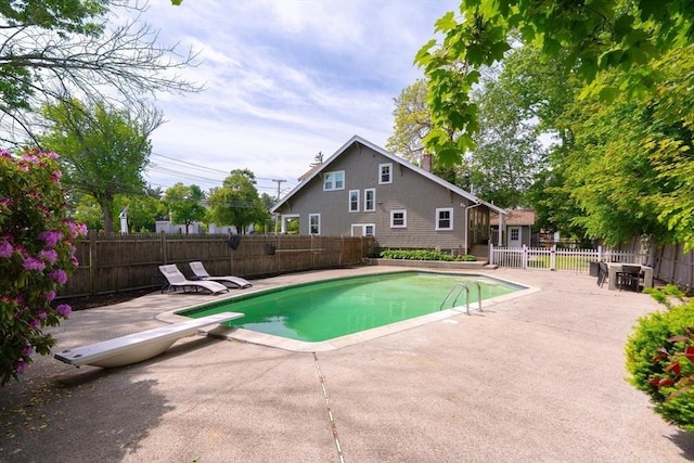 181 Lowell St, Andover, MA 01810 - view of swimming pool featuring a patio area, a diving board, and a fenced backyard
