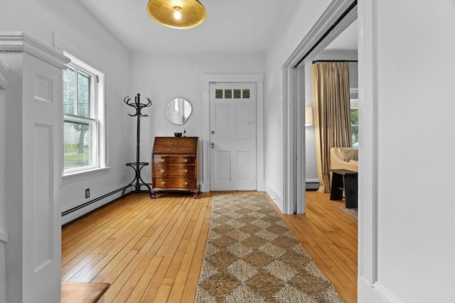 181 Lowell St, Andover, MA 01810 - foyer featuring light wood finished floors and a baseboard heating unit