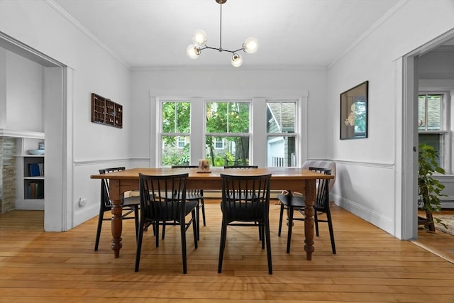 181 Lowell St, Andover, MA 01810 - dining room with light wood-style floors, crown molding, and a chandelier