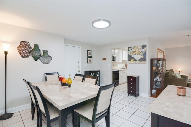 dining area with light tile patterned floors and baseboards